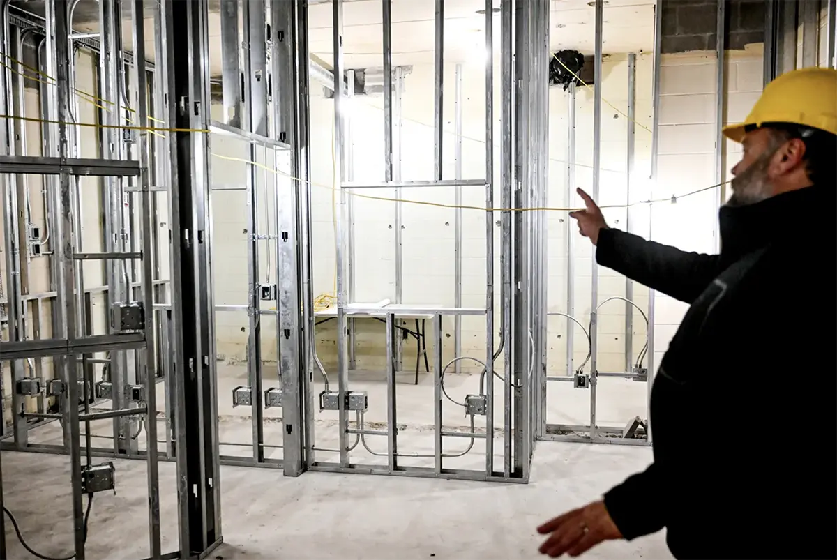Ovation Director Dominic Cochran points out the framing for the Lansing Pubic Media Center recording studio